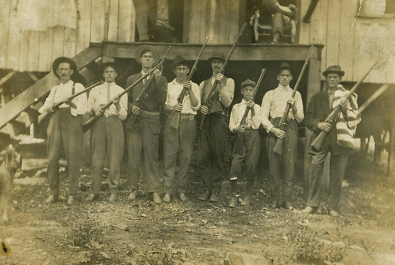 Miners posing with their guns in Eskdale, West Virginia during the Paint--Cabin Creek strike from 1912-1913.
